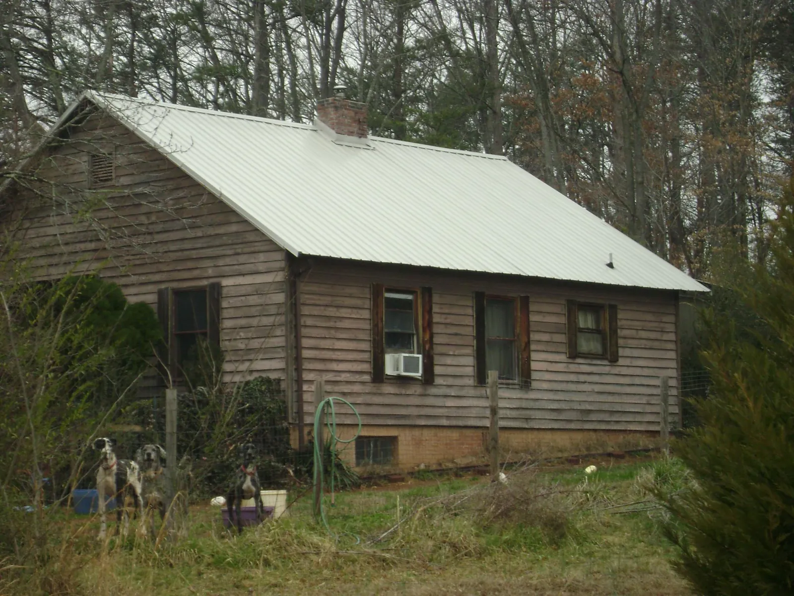 White metal roof on an old wood sided farmhouse, from a Metal Roof Installation job in Elton